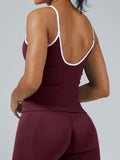 Back view of maroon burgundy seamless cami tank top showing white contrast straps and ribbed hem detail, athletic activewear with removable pads