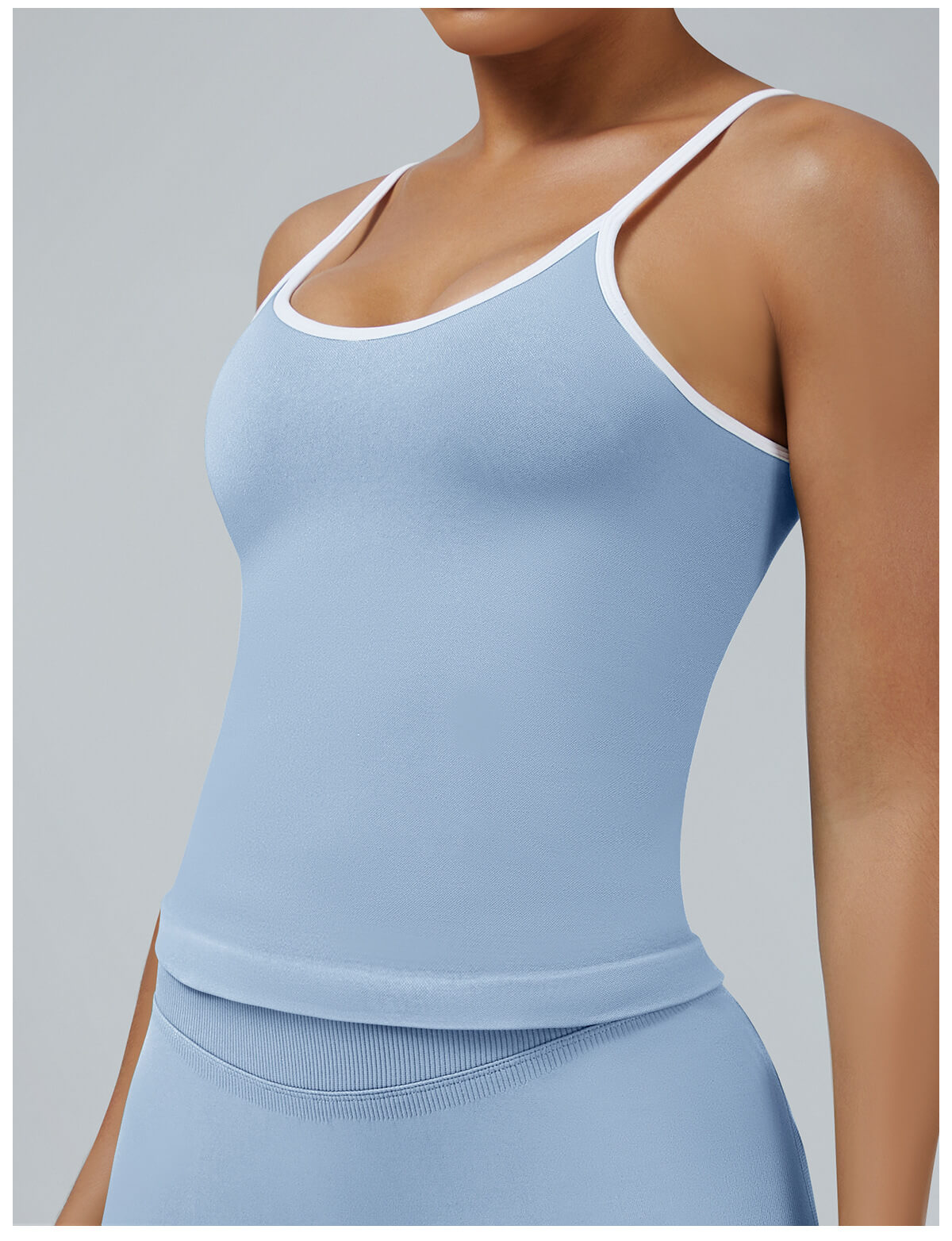 Baby blue seamless camisole tank top with removable pads and white edges, soft-toned activewear for yoga and leisure sports