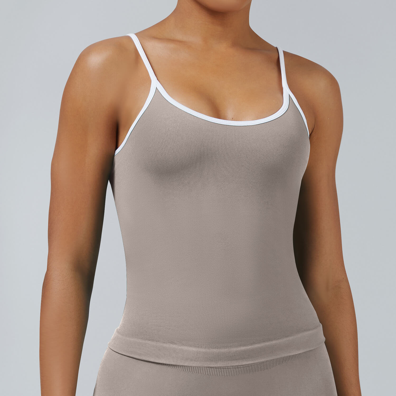 Khaki seamless tank top with removable chest pads and white binding detail, comfortable activewear for gym and leisure