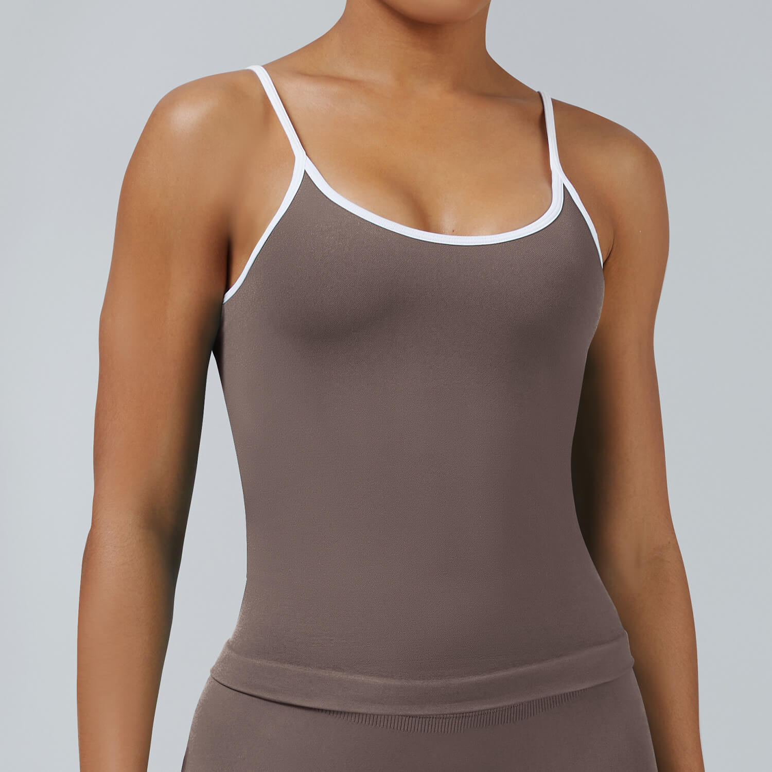 Mocha brown seamless camisole tank top with removable pads featuring white trim, versatile for yoga and everyday athletic wear